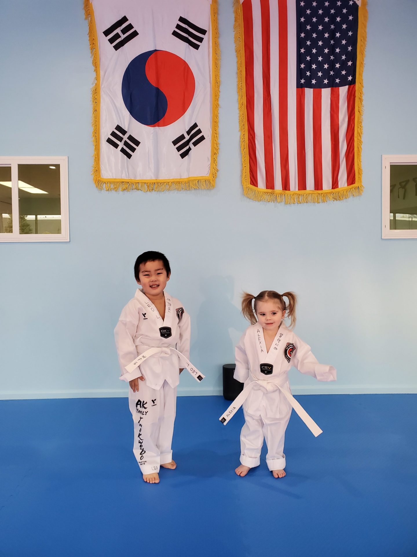 Two young students smiling for photo in their Gi